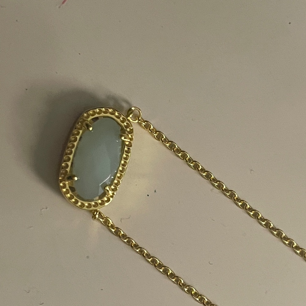 Mint green Kendra Scott necklace.